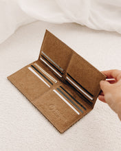 Load image into Gallery viewer, Brown wallet made from eco friendly material texon vogue with credit cards inside being opened by female hand