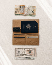 Load image into Gallery viewer, Northern Olive Travel Wallet in brown holding passport and cards  with  AUD and USD beside the wallet. 
